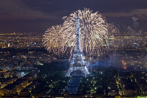 The Eiffel Tower is illuminated during the traditional Bastille Day fireworks display in Paris