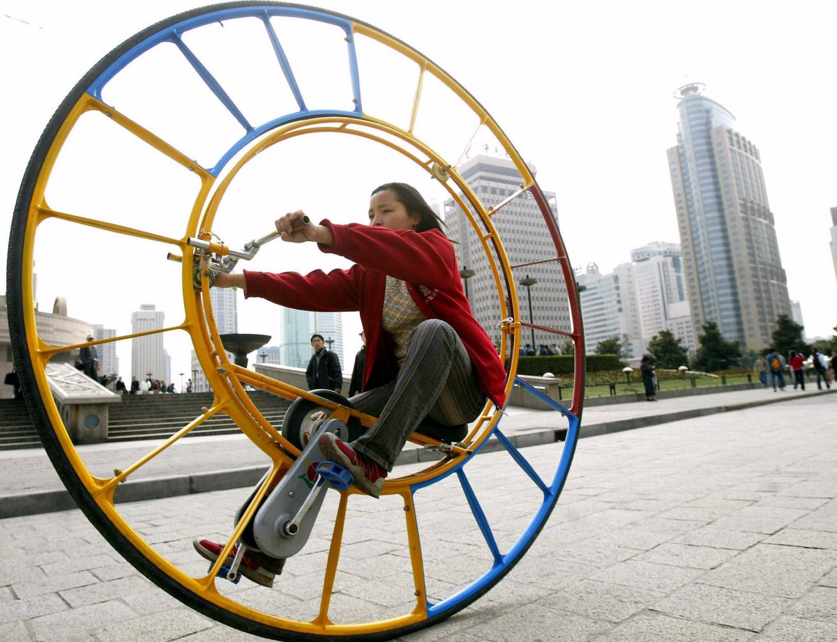 a-woman-rides-an-unicycle-at-a-park-in-shanghai-february-28-2004-the-unicycle-was-designed-several-years-ago-by-chinese-inventor-li-yongli-who-called-it-the-number-one-vehicle-in-the-world