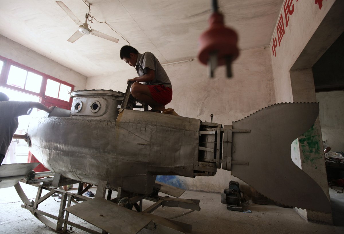 a-worker-polishes-the-surface-of-an-unfinished-miniature-submarine-at-a-workshop-of-zhang-wuyi-a-local-farmer-who-is-interested-in-scientific-inventions-in-qingling-village-on-the-outskirts-of-wuhan