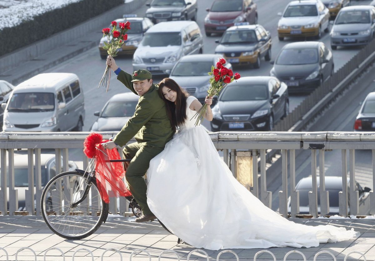 an-engaged-couple-poses-on-a-pedestrian-bridge-on-valentines-day-in-central-beijing