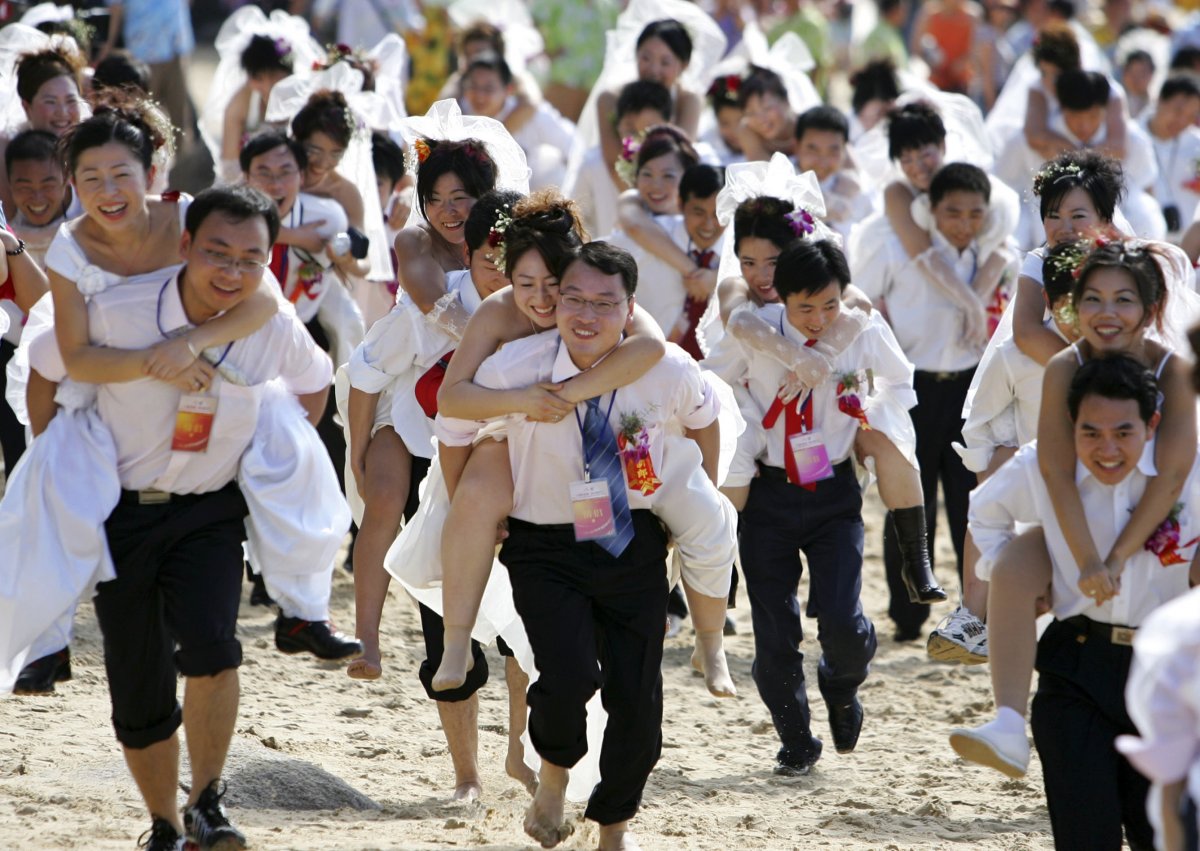 during-a-mini-marathon-celebrating-the-new-year-grooms-run-with-their-brides-in-sanya-in-south-chinas-hainan-province