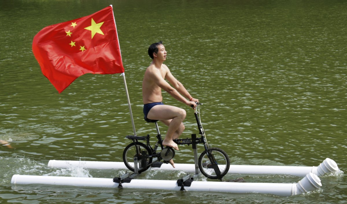 liu-wanyong-created-this-improvised-bicycle-which-is-held-afloat-by-plastic-tubes-in-zhenning-in-the-guizhou-province