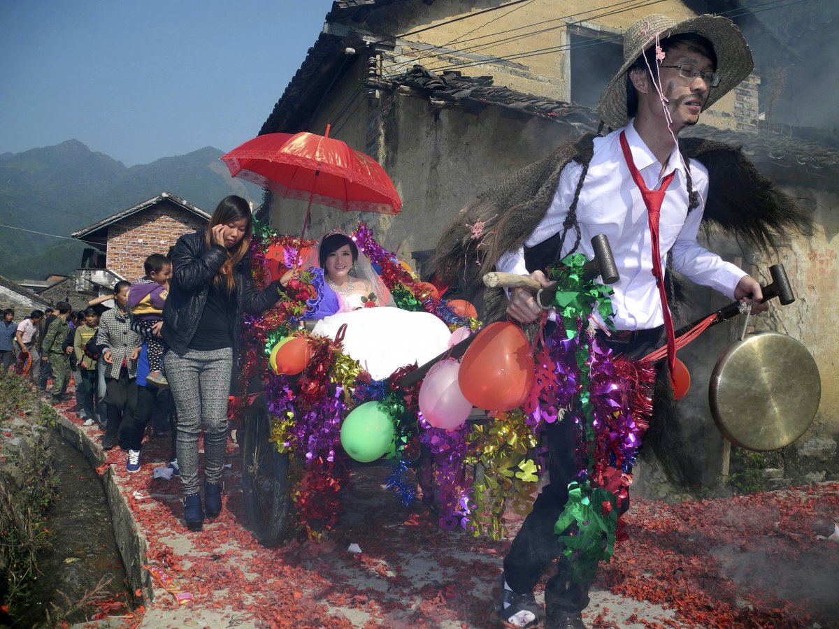 newlywed-groom-meng-jun-29-pulls-a-cart-carrying-his-bride-zeng-shuangying-25-during-a-traditional-wedding-ceremony-in-the-guangxi-zhuang
