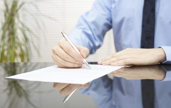 businessman is signing contract to finalize deal