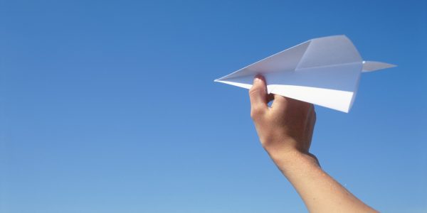Hand with paper plane