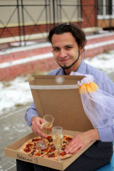 Pic shows: 22-year-old Russian marries a pizza.nnA lonely Russian gourmet fed up of not having a better half has married a pizza.nnThe bizarre wedding ceremony took place in a pizzeria in the city of Tomsk, in the Tomsk Oblast region that is located in south-central Russia.nnThe man who was not named said he came up with the idea because she was fed up of being alone.nnHe said: "At some point I realized that half of my friends are complaining about their better half, while the others were complaining about the lack of a better half."nn"Love between two humans is a complicated wild thing. I was grateful that I had at least my love of food and then it came to me that actually love for food remains stable no matter what."nn"Pizza would not reject you or betray you, and speaking quite frankly and sincerely, I love it."nnSceptical Russian authorities refused to give official permission to register the unusual marriage at a registry office, and the church also turned him down.nnSo in the end the unusual ceremony went ahead in one of the city¿s pizzerias. Managers and cooks at the restaurant even went as far as to provide the man with a certificate of marriage, and the pizza bride was covered in a bridal veil.nnAfter that the happy groom posed in front of many cameras with his "wife". Details of what they did on their honeymoon night together were not revealed.nn(ends)