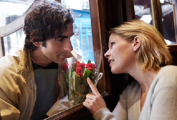 getty_rf_photo_of_man_giving_woman_flowers