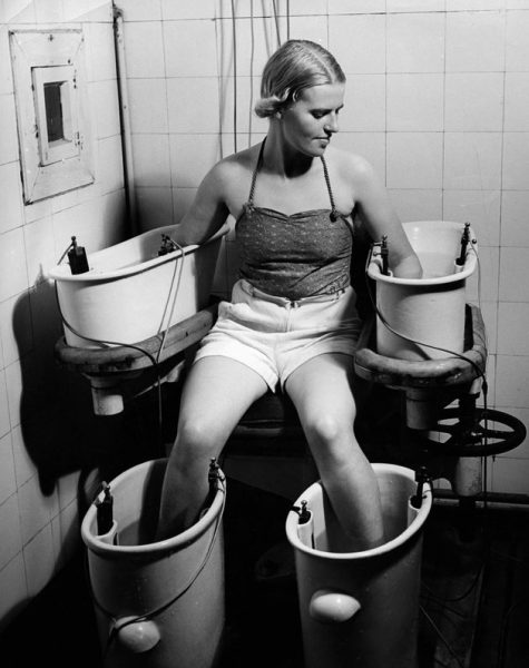 (GERMANY OUT) Four-cell galvanic bath: A young woman holds her arms and legs in four water bathes with electric current, this procedure has positive effect on blood circulation - around 1938 - Photographer: Hedda Walther - Published by: 'Die Dame' 21/1938 Vintage property of ullstein bild  (Photo by Hedda Walther/ullstein bild via Getty Images)