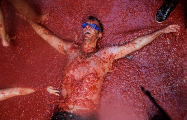a-man-lies-in-tomato-pulp-during-the-annual-tomatina-festival-in-bunol-near-valencia-spain