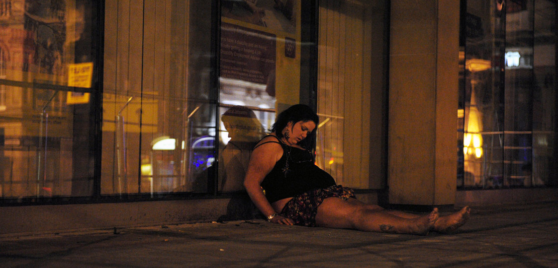 A woman lies on the street during a night out in Newcastle, northern England