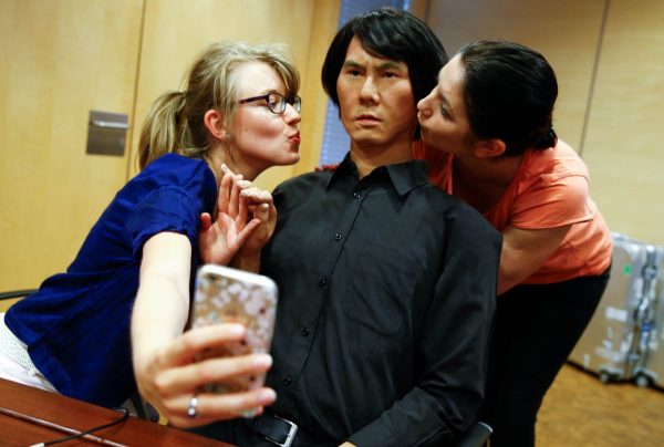 employees-of-germanys-biggest-retailer-metro-ag-take-a-selfie-as-they-kiss-hi-4-a-life-size-humanoid-robot-in-duesseldorf-germany