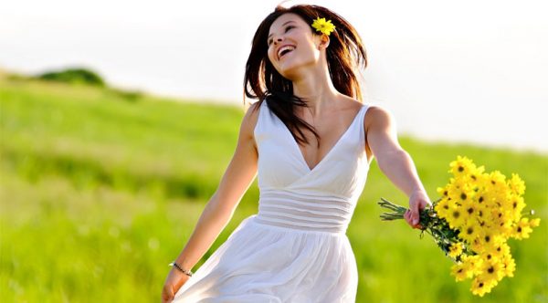 happy-woman-holding-flowers-in-the-field
