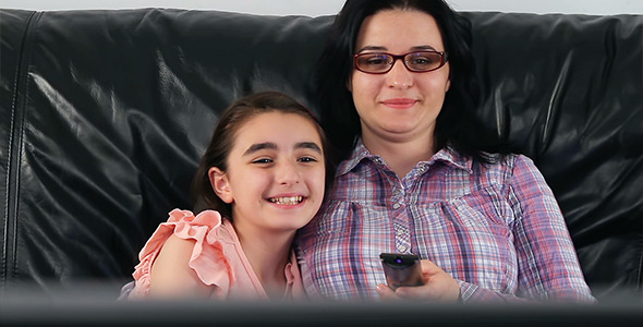 Young mother and daughter watching TV 590x300